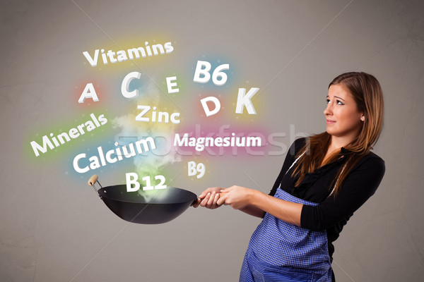 Young woman cooking vitamins and minerals Stock photo © ra2studio