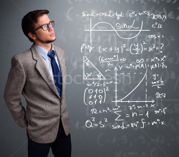 Handsome school boy thinking about complex mathematical signs Stock photo © ra2studio