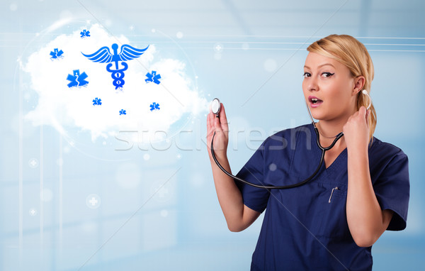 Young doctor with abstract cloud and medical icons Stock photo © ra2studio