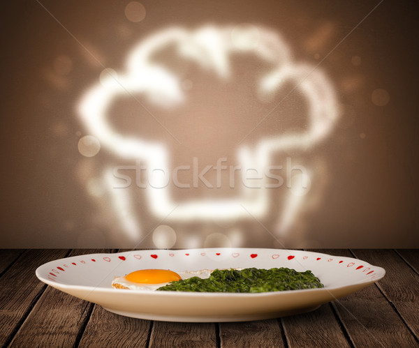 Delicious food plate with chef cook hat Stock photo © ra2studio