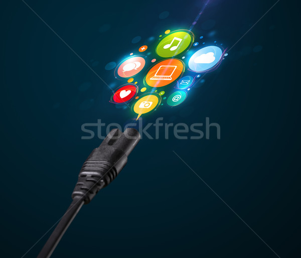 Social media icons coming out of electric cable Stock photo © ra2studio