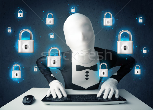 Hacker in disguise with virtual lock symbols and icons Stock photo © ra2studio