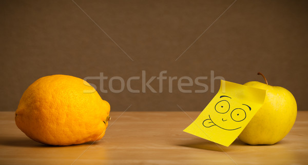 Apple with post-it note sticking out tongue to lemon Stock photo © ra2studio