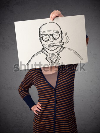 Woman holding a cardboard with a smoking man on it in front of h Stock photo © ra2studio