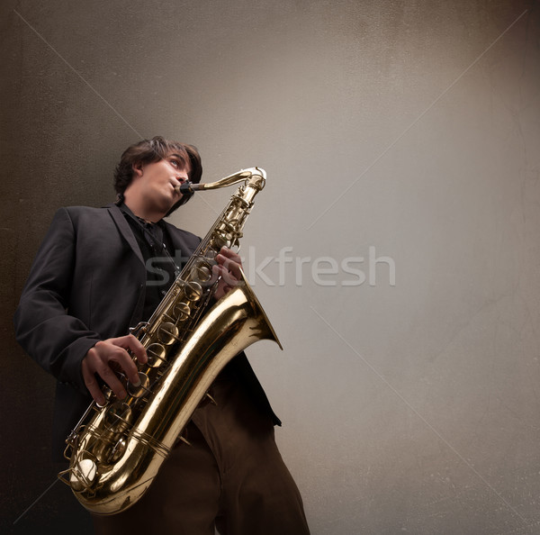 Young musician playing on saxophone Stock photo © ra2studio