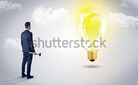 Businessman on rock mountain with idea bulb Stock photo © ra2studio