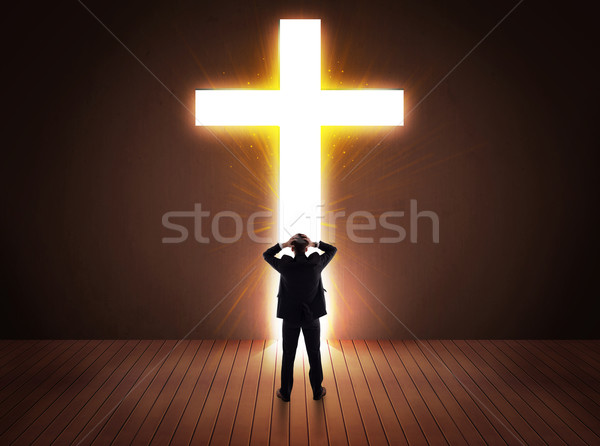 Man looking at bright cross sign  Stock photo © ra2studio