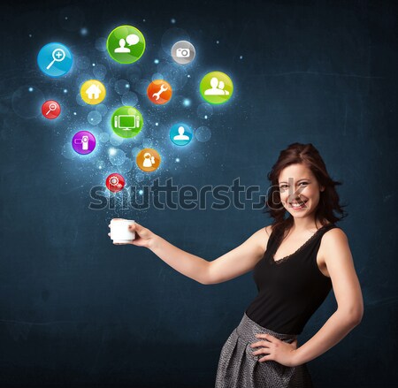 Businesswoman holding a white cup with setting icons Stock photo © ra2studio