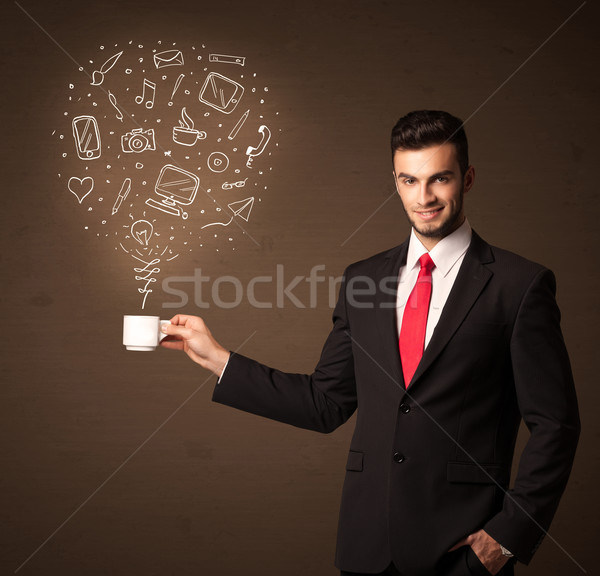 Businessman holding a white cup with social media icons Stock photo © ra2studio