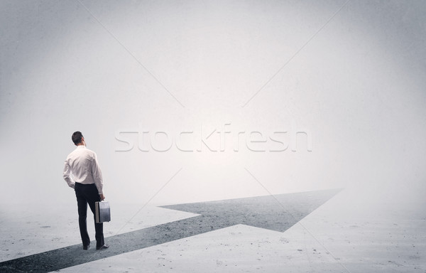 Standing salesman looking ahead with arrow Stock photo © ra2studio