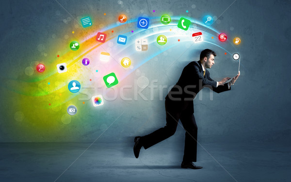 Running businessman with application icons from device Stock photo © ra2studio