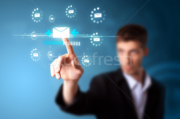 Businessman pressing virtual messaging type of icons Stock photo © ra2studio