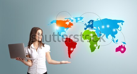 Young woman holding a laptop and presenting colorful world map Stock photo © ra2studio