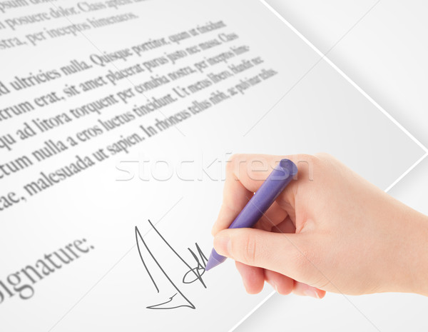 Stock photo: Hand writing personal signature on a paper form