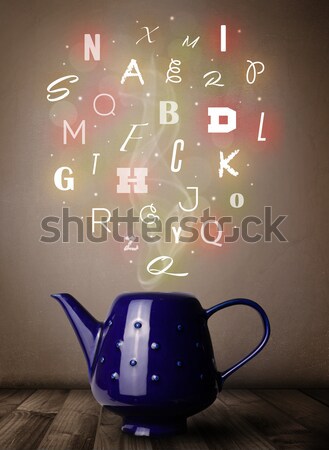 Stock photo: Tea pot with colorful letters