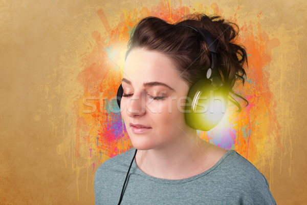 Young woman with headphones listening to music Stock photo © ra2studio