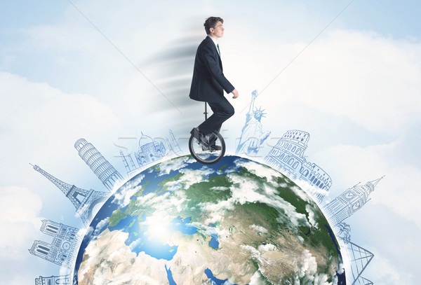 Stock photo: Man riding unicycle around the globe with major cities