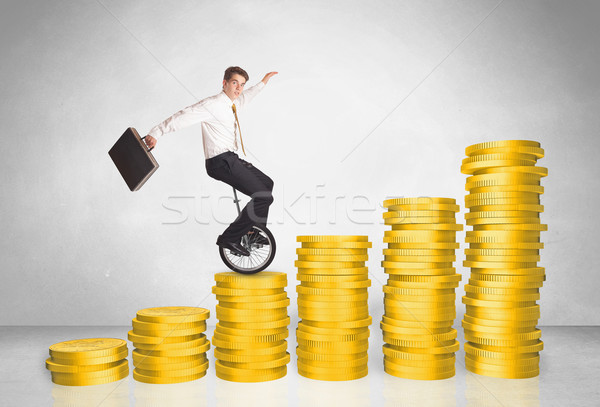 Business man riding monocycle up on coin graph Stock photo © ra2studio