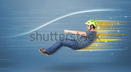 Young man driving in imaginary fast car with blurred lines  Stock photo © ra2studio