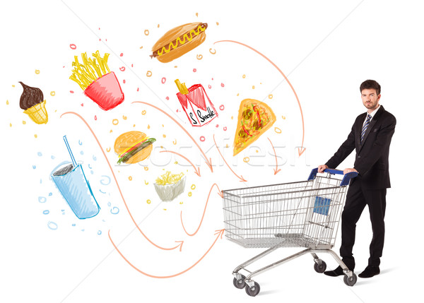 Man with shopping cart with toxic junk food Stock photo © ra2studio