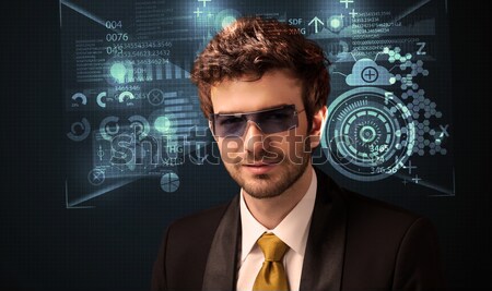 Young man looking with futuristic smart high tech glasses  Stock photo © ra2studio