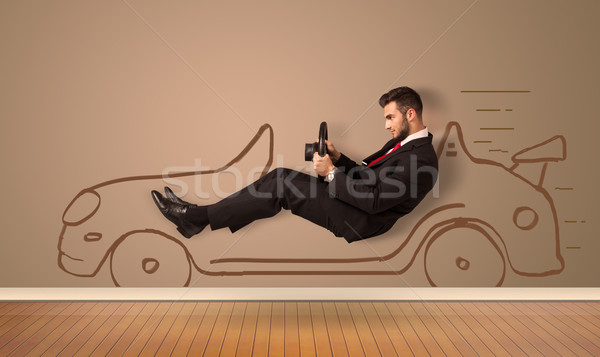 Happy man driving an hand drawn car on the wall Stock photo © ra2studio