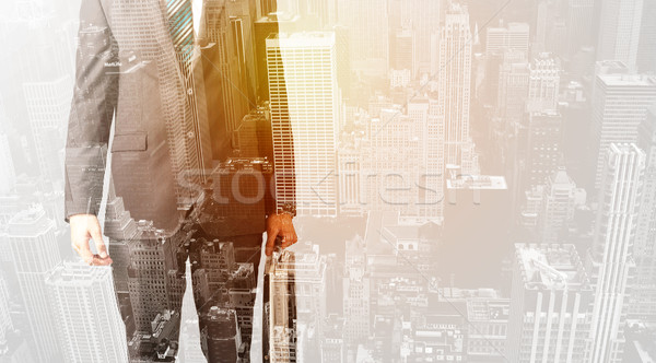 Business person with warm color overlay of city background Stock photo © ra2studio