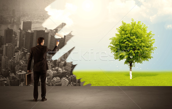 Salesman painting tree instead of city Stock photo © ra2studio