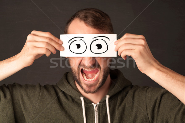 Funny man looking with hand drawn paper eyes Stock photo © ra2studio