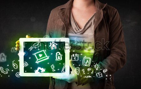 Person holding tablet with green media icons and symbols Stock photo © ra2studio