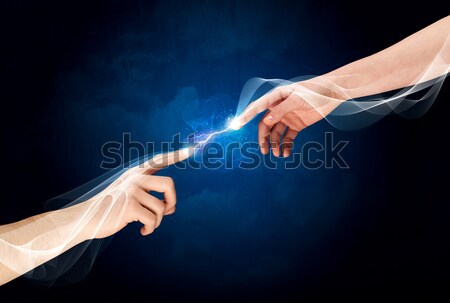 Stock photo: Hands connecting through fingers in space