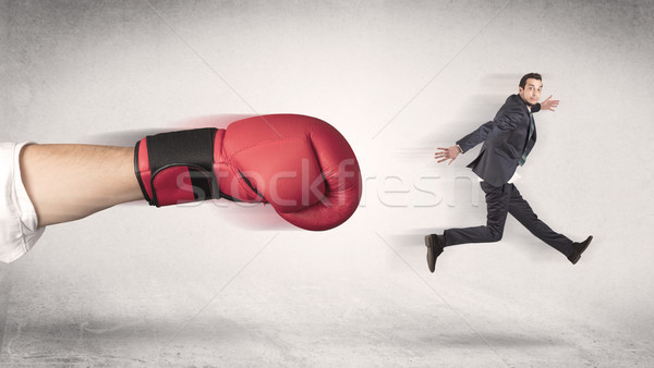 Businessman gets fired by a huge boxing hand Stock photo © ra2studio