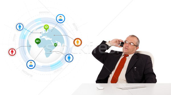 businessman sitting at desk and making a phone call with globe and social icons, isolated on white Stock photo © ra2studio