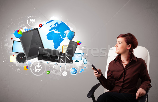 young woman sitting and browsing on her phone Stock photo © ra2studio