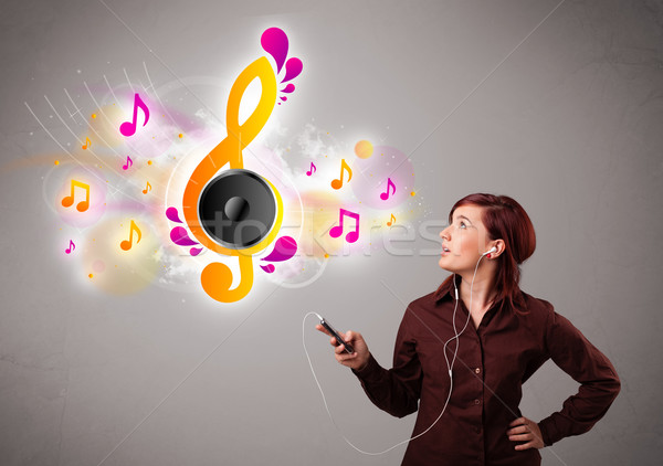 Stock photo: pretty girl singing and listening to music with musical notes
