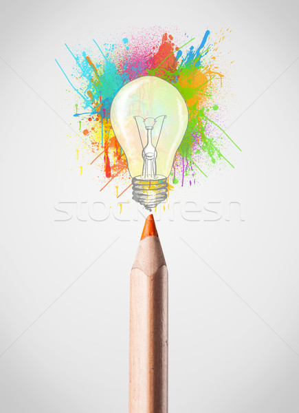 Pencil close-up with colored paint splashes and lightbulb Stock photo © ra2studio