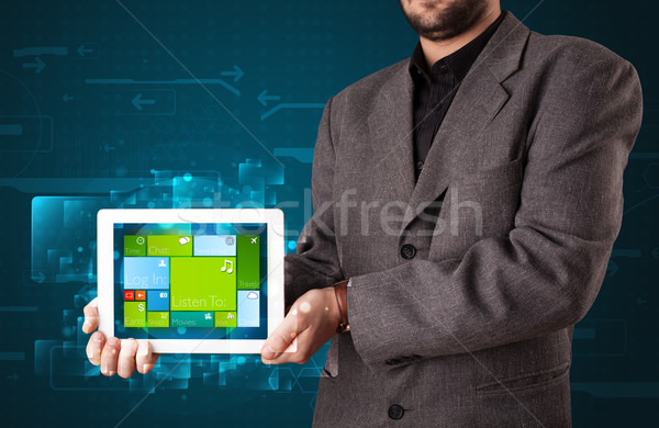 Young businessman holding a tablet with modern software operational system Stock photo © ra2studio