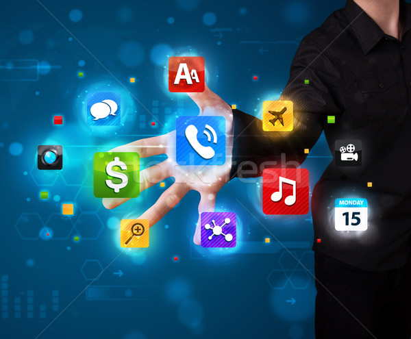 Man pressing various collection of high tech buttons Stock photo © ra2studio