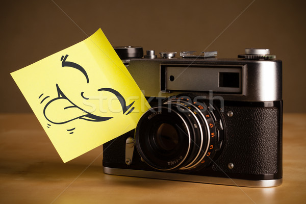 Post-it note with smiley face sticked on photo camera Stock photo © ra2studio