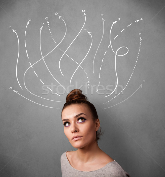 Young woman with arrows coming out of her head Stock photo © ra2studio