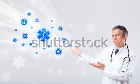Doctor with blue medical icons Stock photo © ra2studio