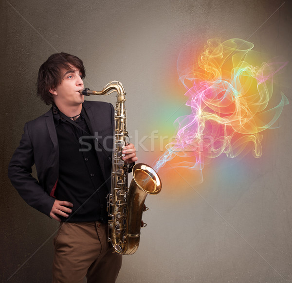 Attractive musician playing on saxophone with colorful abstract  Stock photo © ra2studio