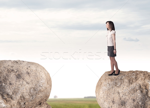 Businesswoman on rock mountain Stock photo © ra2studio