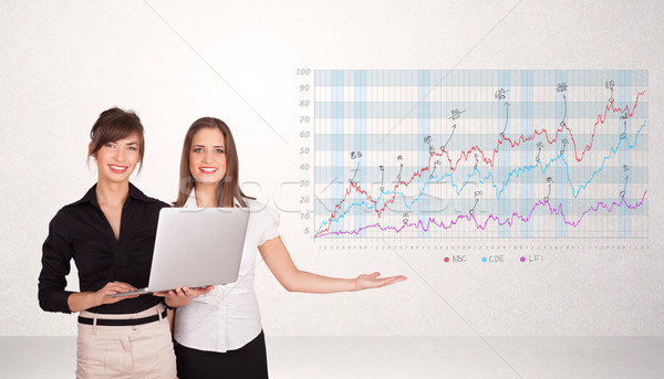 Young business woman presenting stock market diagram Stock photo © ra2studio