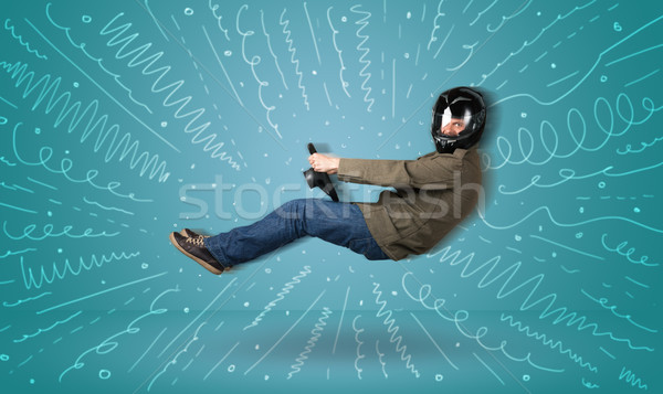 Stock photo: Funny guy drives an imaginary vehicle with drawn lines around hi