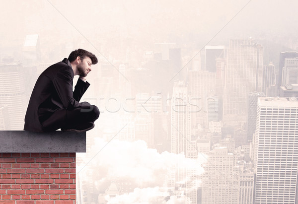 Office worker sitting on rooftop in city Stock photo © ra2studio