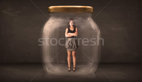 Stock photo: Businesswoman captured in a glass jar concept