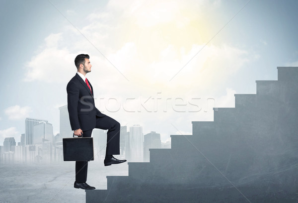 Biznesmen wspinaczki w górę konkretnych schody miasta Zdjęcia stock © ra2studio