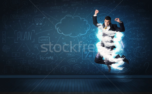 Happy business man jumping with storm cloud around him  Stock photo © ra2studio