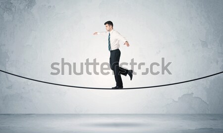 Sales guy balancing on tight rope Stock photo © ra2studio